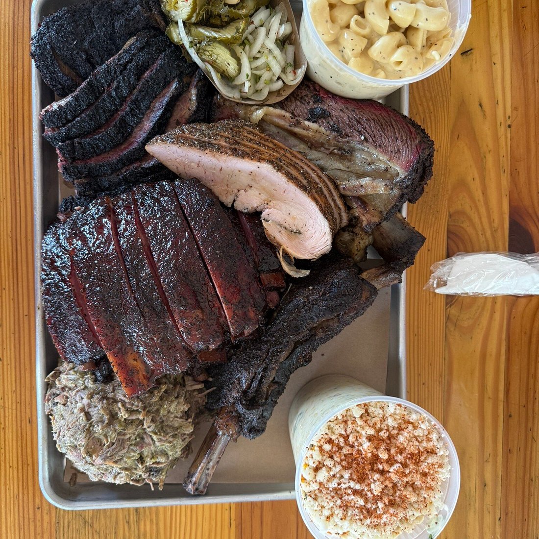 2M Smokehouse signature dishes Chop Brisket Meal, Brisket Chopped Sandwich, Brisket Cheddar Melt Sandwich.